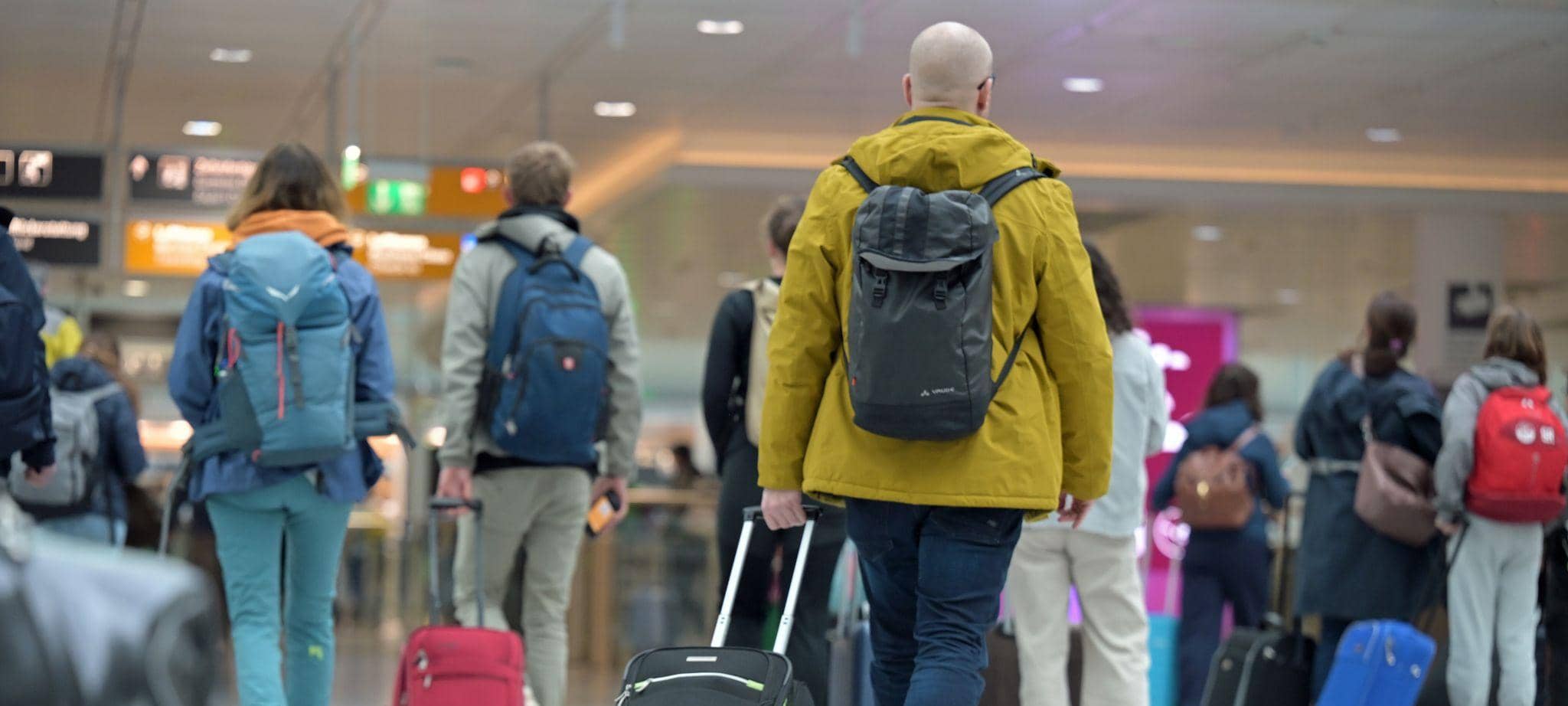 Reisegäste gehen zum Check-in am Flughafen.
